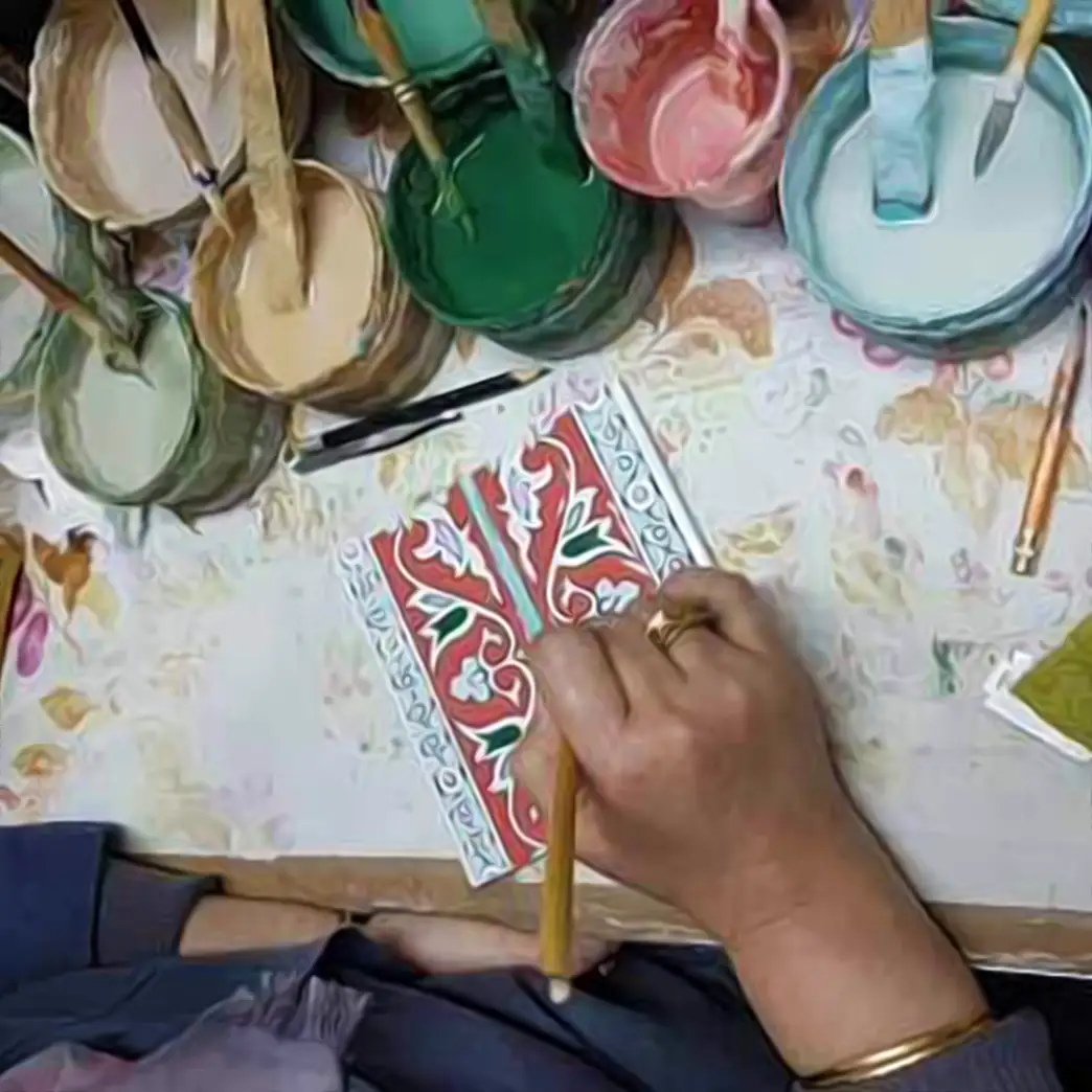 A tile being hand painted